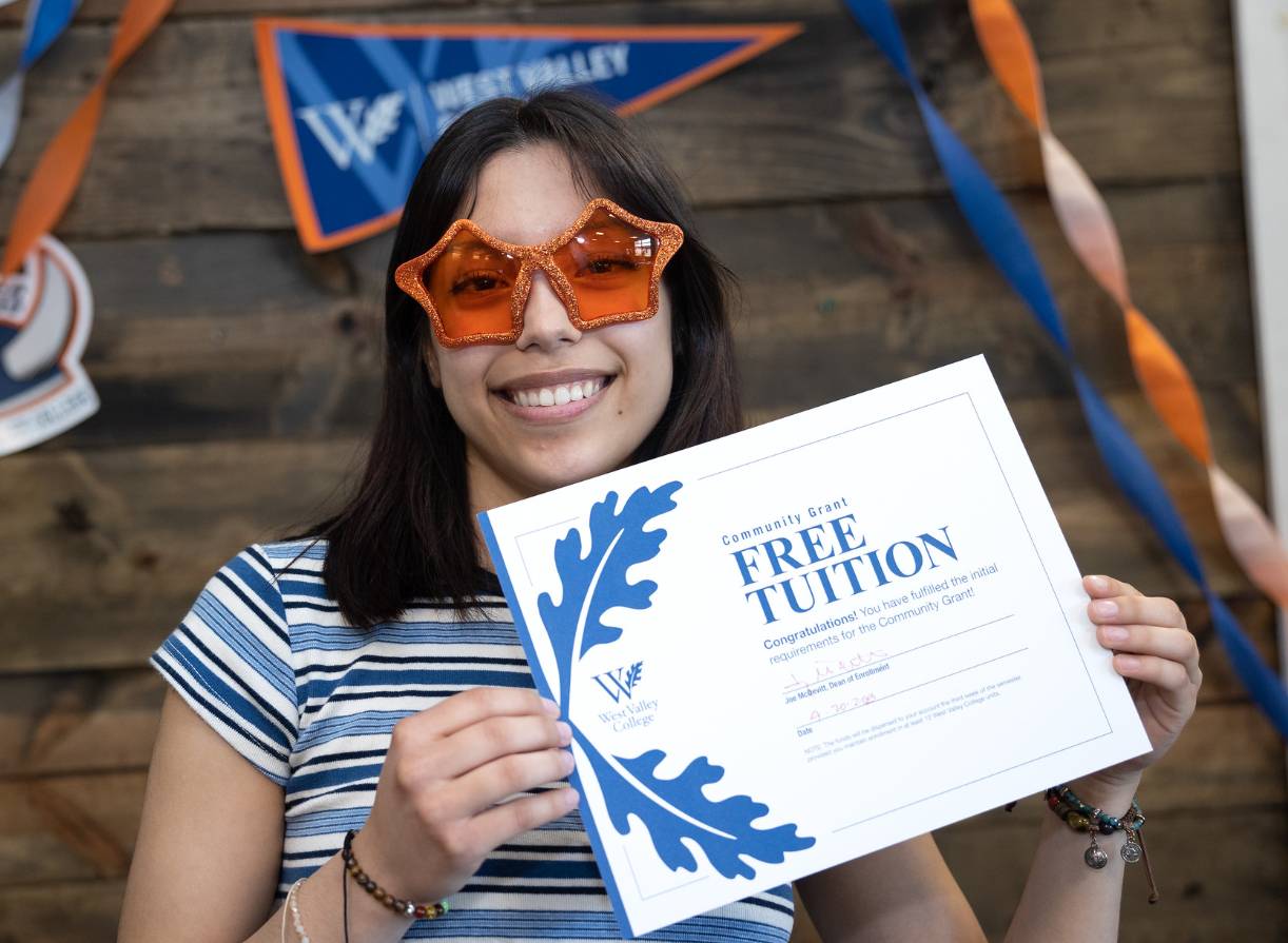 Student with Free Tuition sign