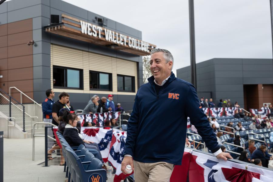 Chancellor Brad Davis smiling at West Valley baseball field