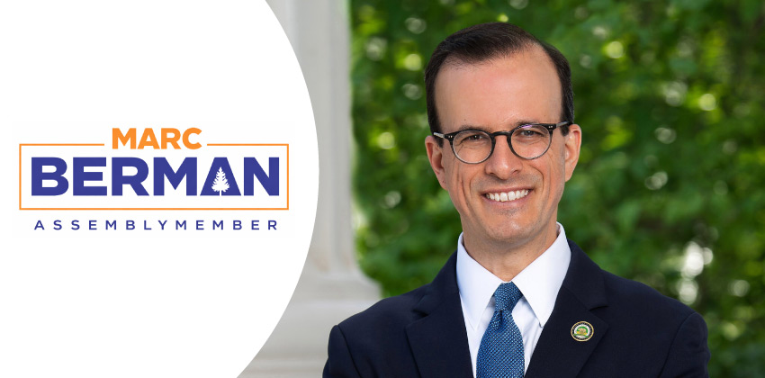 Assemblymember Marc Berman smiling confidently in next to his own logo